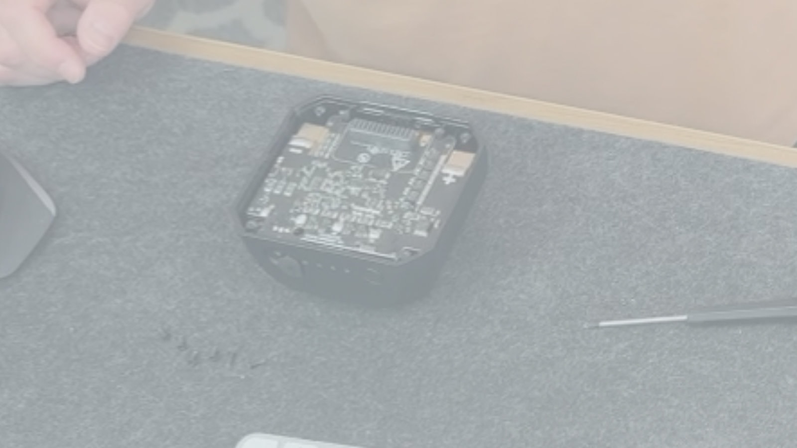 Blurred image of computer hardware on desk.